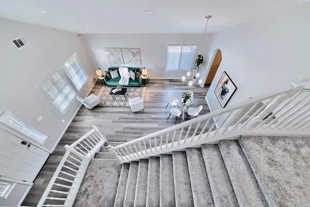 a bedroom with furniture and a wooden floor