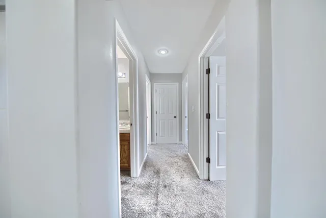a view of a hallway with wooden shelves