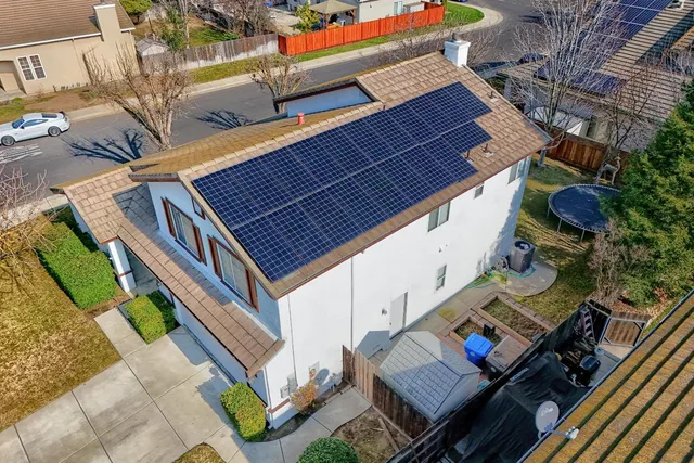 a aerial view of a house with a yard