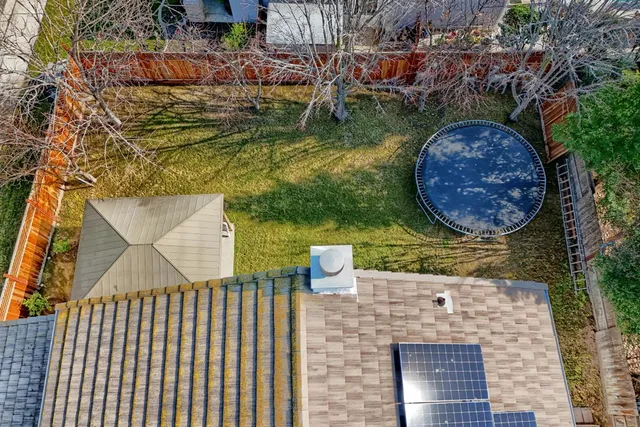 an aerial view of a residential houses with outdoor space