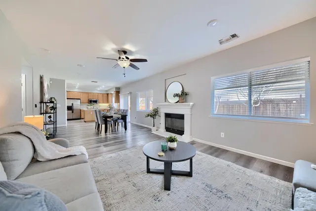 a living room with furniture a fireplace and a window