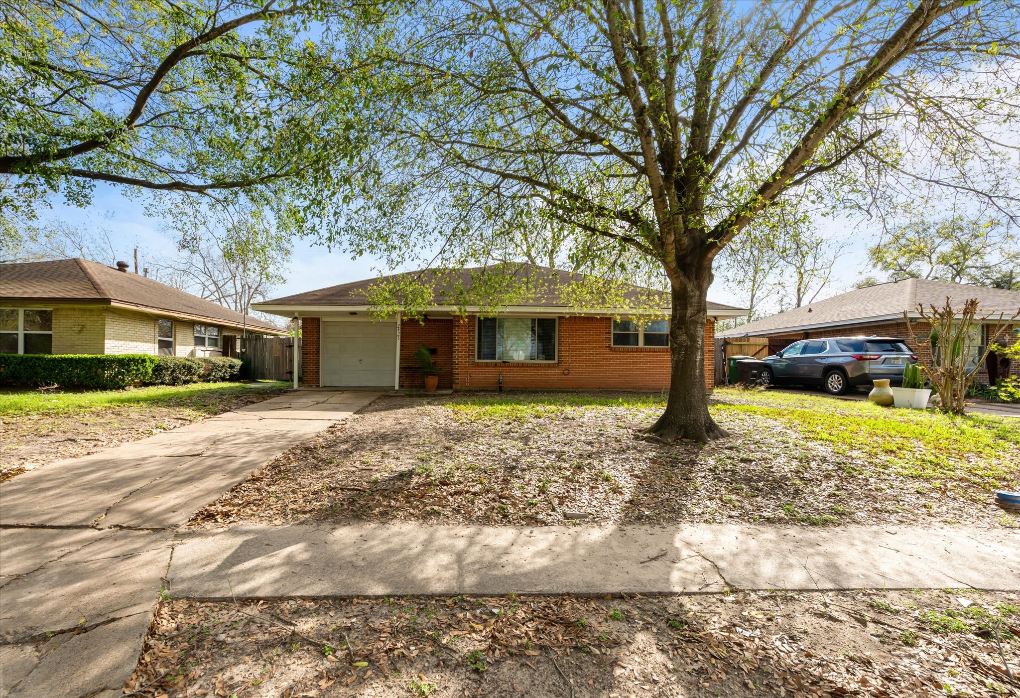 a front view of a house with a yard and trees