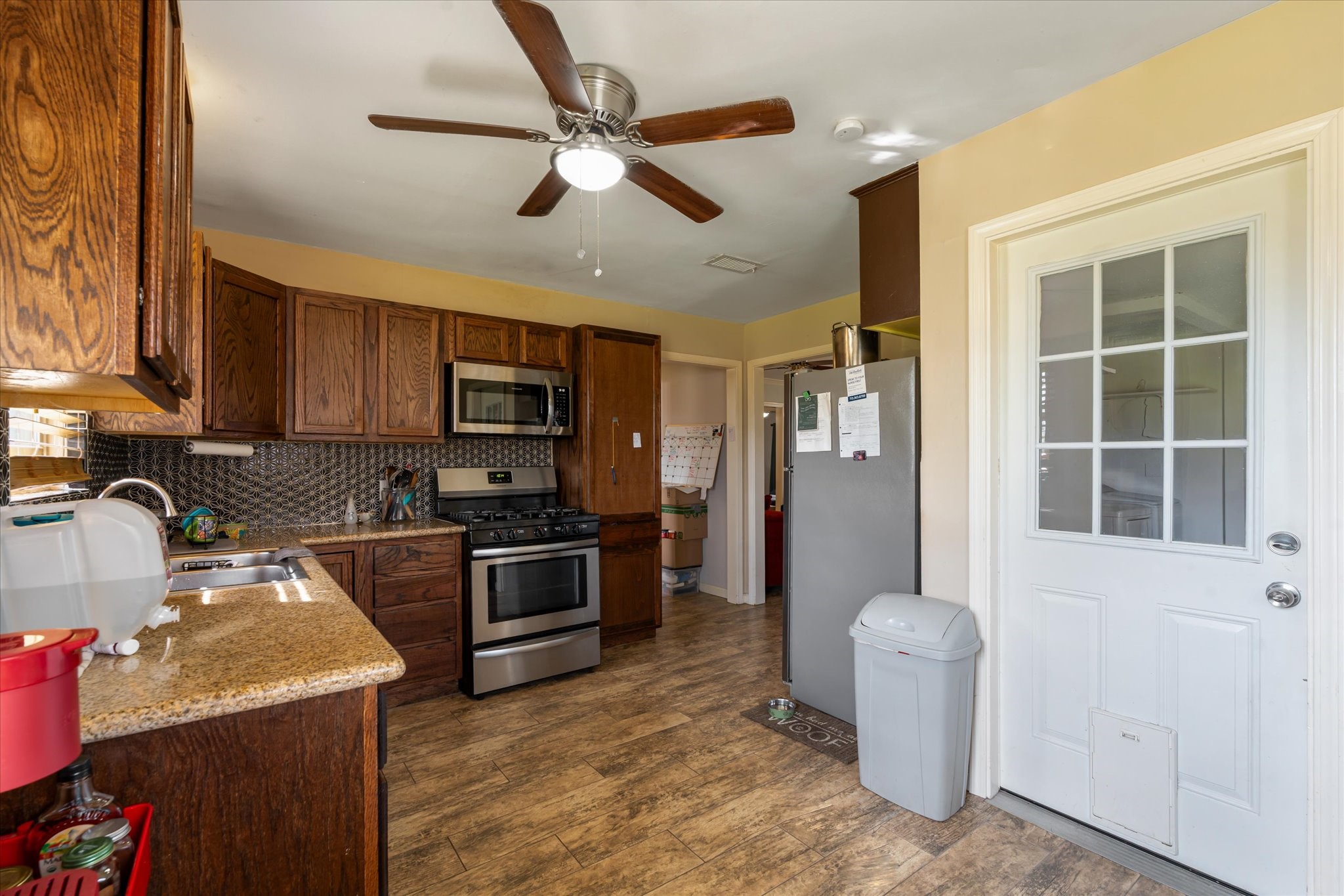 2423 Metz Street Houston, TX 77034 - Photo 11 of 22 a kitchen with sink a refrigerator and cabinets