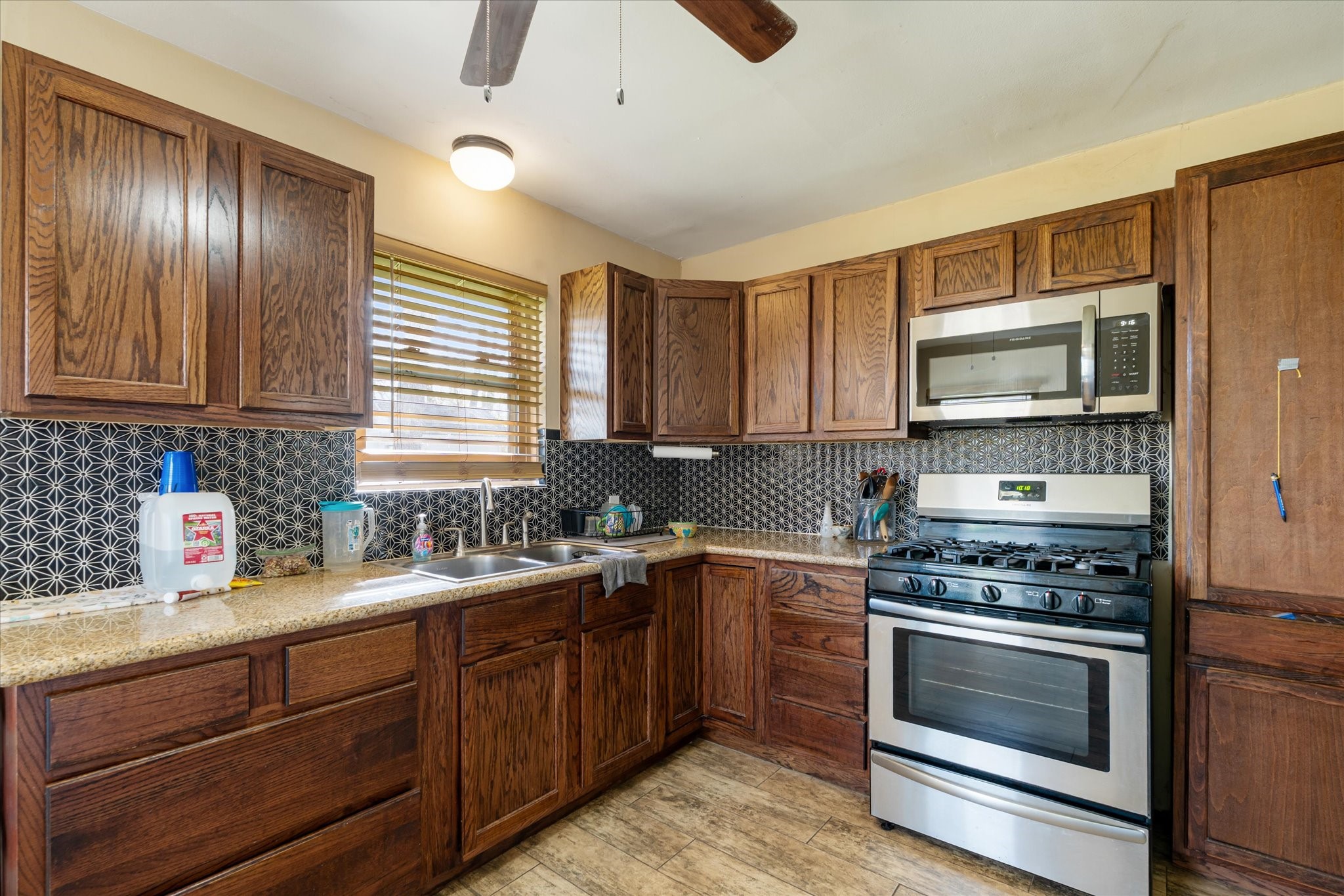 2423 Metz Street Houston, TX 77034 - Photo 13 of 22 a kitchen with a sink stove and microwave