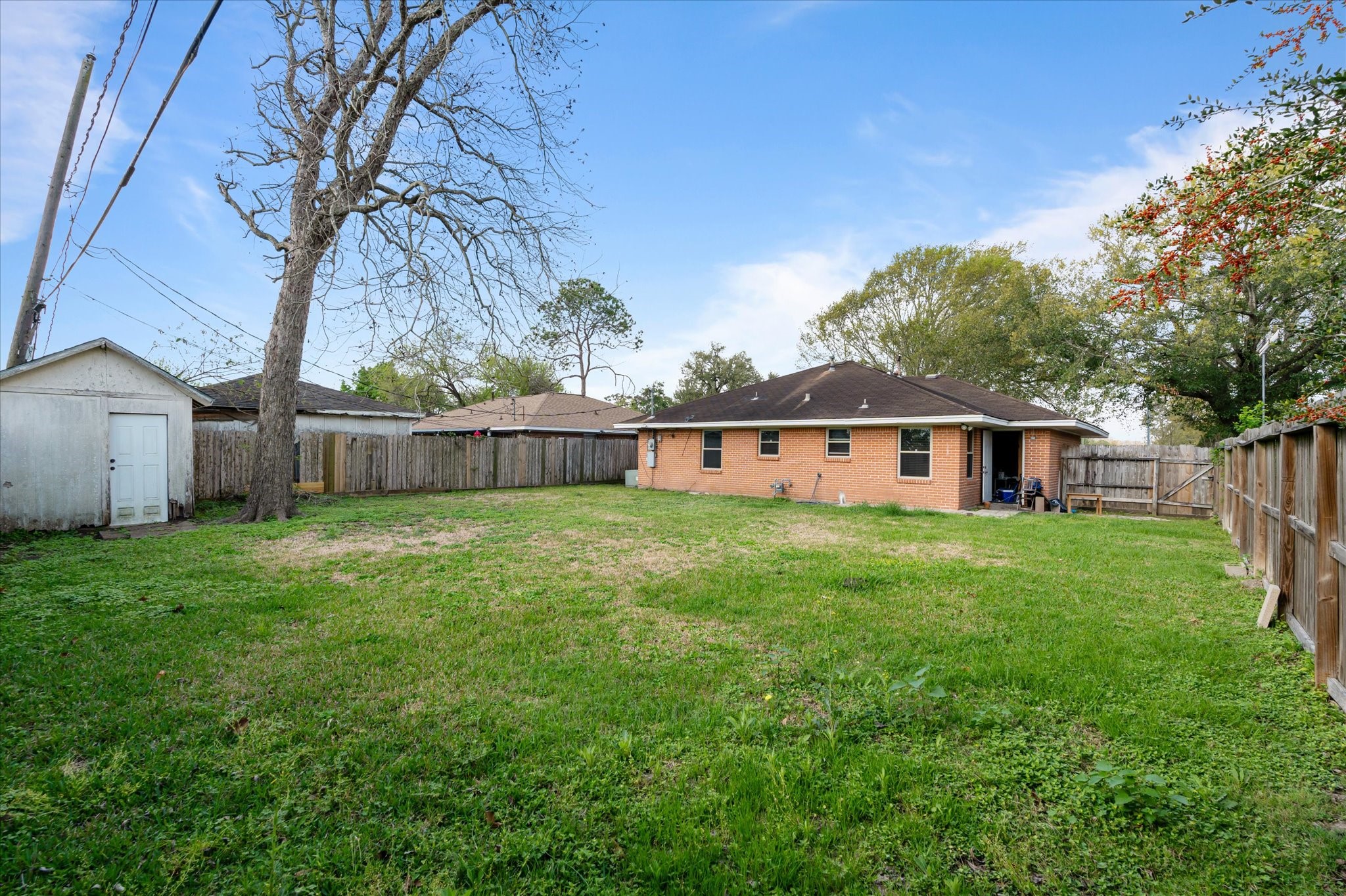 2423 Metz Street Houston, TX 77034 - Photo 20 of 22 a view of a house with backyard and garden