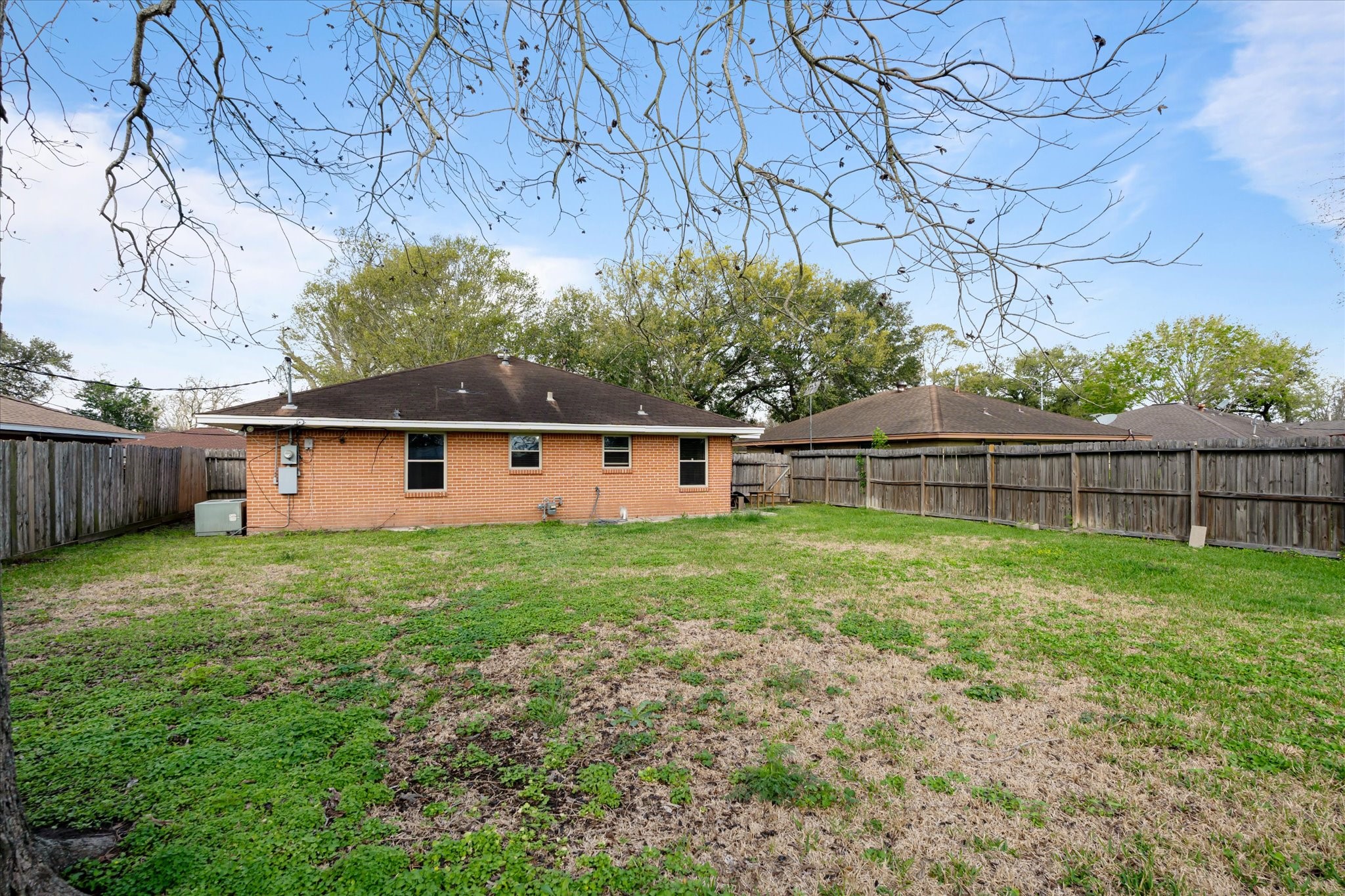 2423 Metz Street Houston, TX 77034 - Photo 21 of 22 a view of backyard with wooden fence and large trees