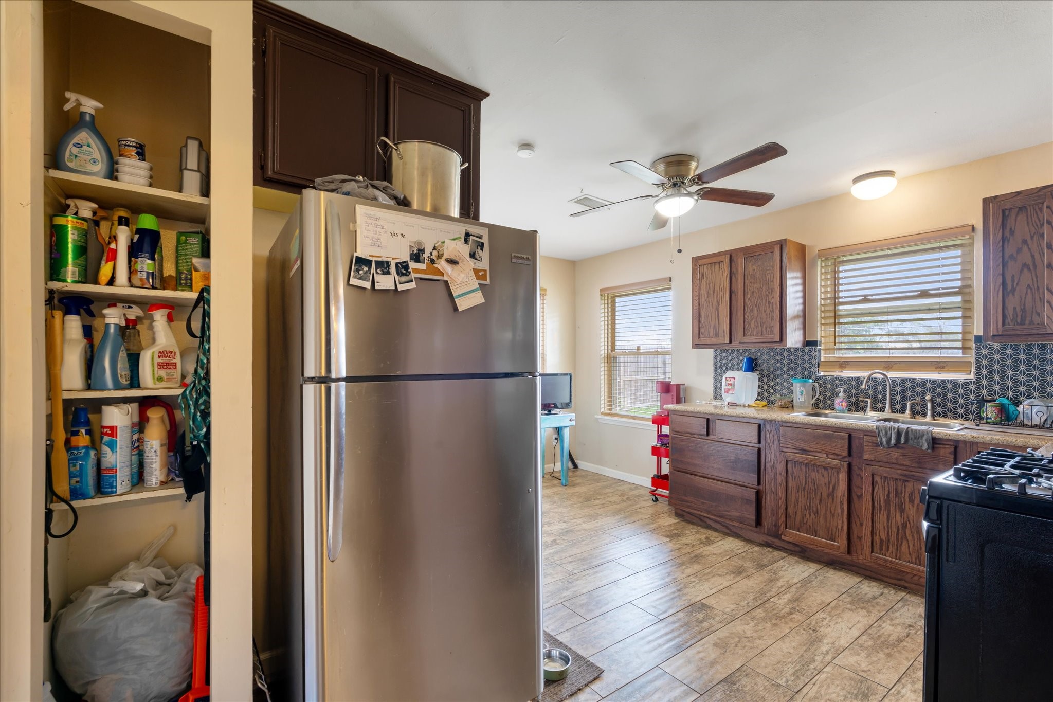 2423 Metz Street Houston, TX 77034 - Photo 8 of 22 a kitchen with stainless steel appliances granite countertop a refrigerator and a stove