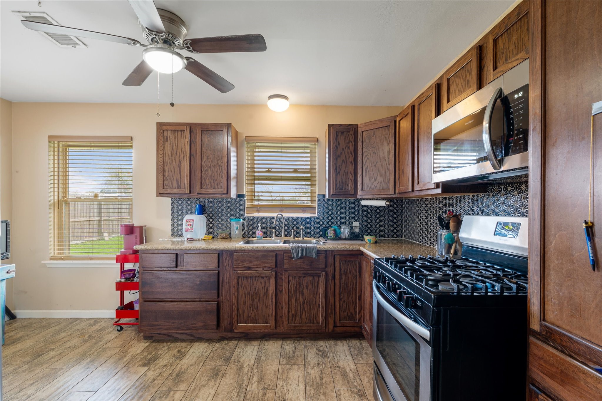 2423 Metz Street Houston, TX 77034 - Photo 9 of 22 a kitchen with granite countertop a stove cabinets and wooden floor