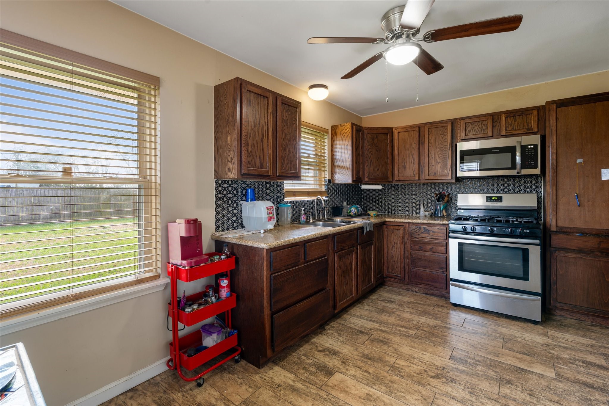 2423 Metz Street Houston, TX 77034 - Photo 10 of 22 a kitchen with stainless steel appliances kitchen island granite countertop a stove sink and cabinets