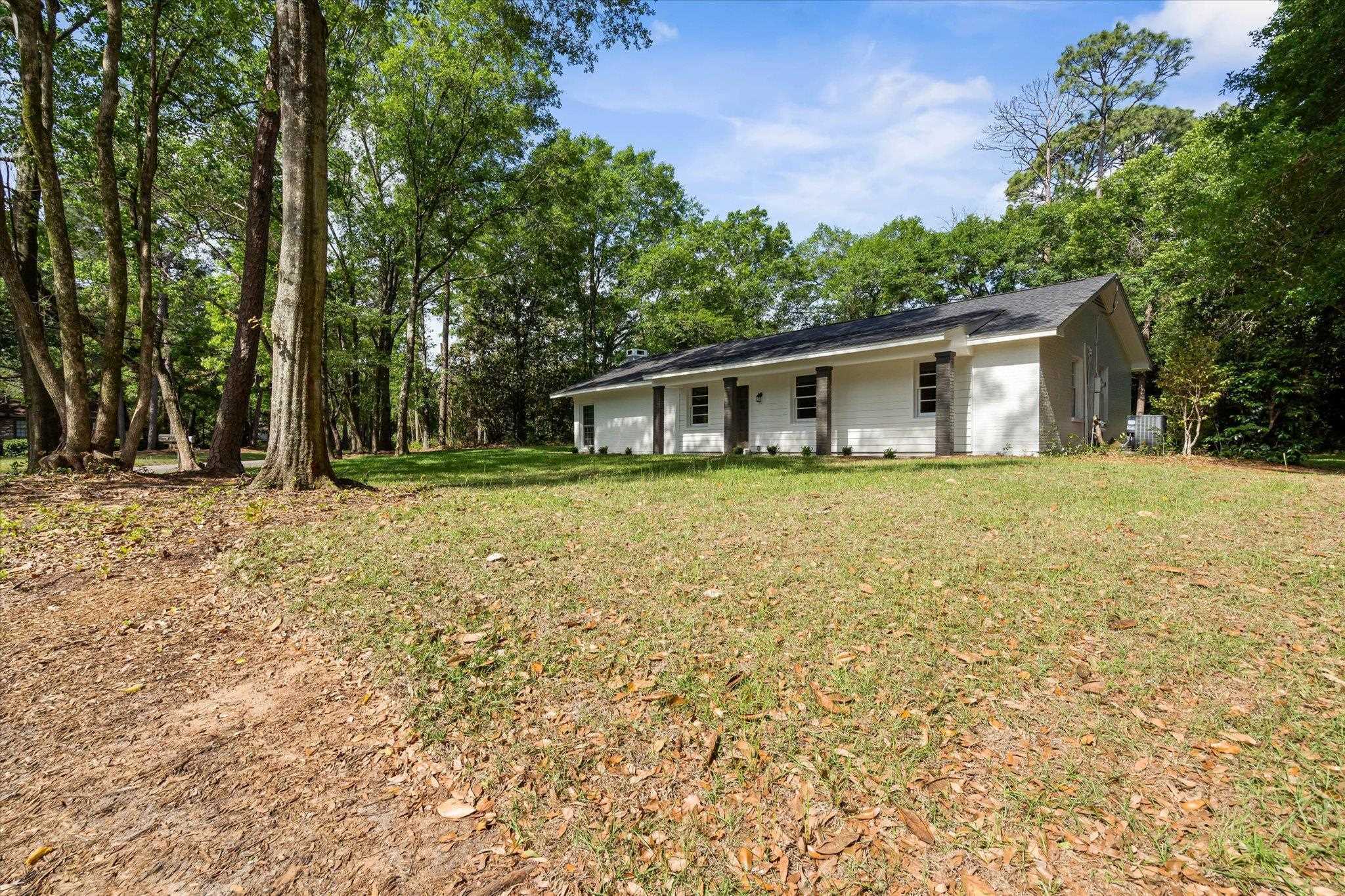 4700 Bit And Spur Road Mobile, AL 36608 - Photo 20 of 21 Rear view of property with a lawn and roof with shingles