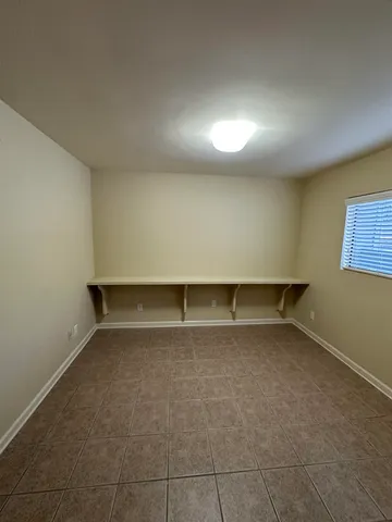 an empty room with a empty space and windows