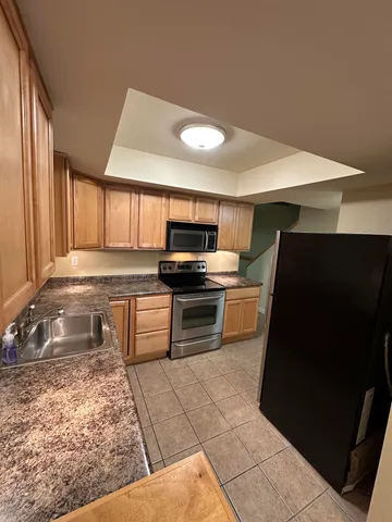 a kitchen with a stove a microwave and a sink