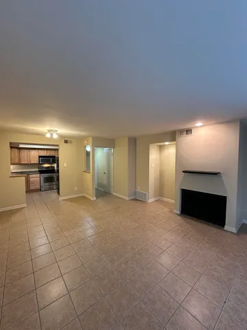an empty room with furniture and natural light