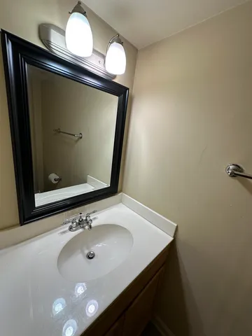 a bathroom with a sink vanity and mirror