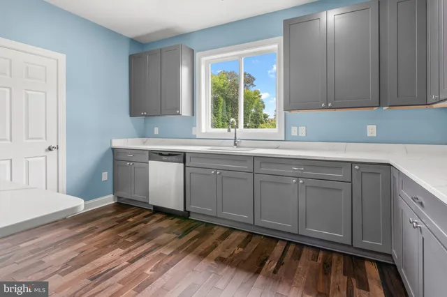 a kitchen with a sink window and cabinets