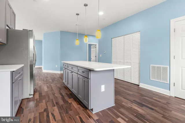 a kitchen with sink cabinets and wooden floor