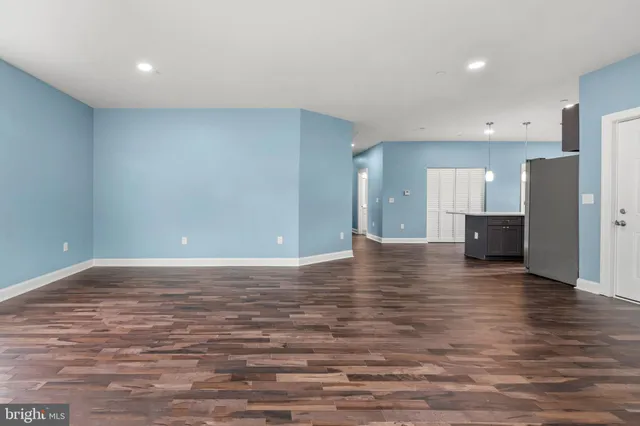 a view of a kitchen with a refrigerator and a stove