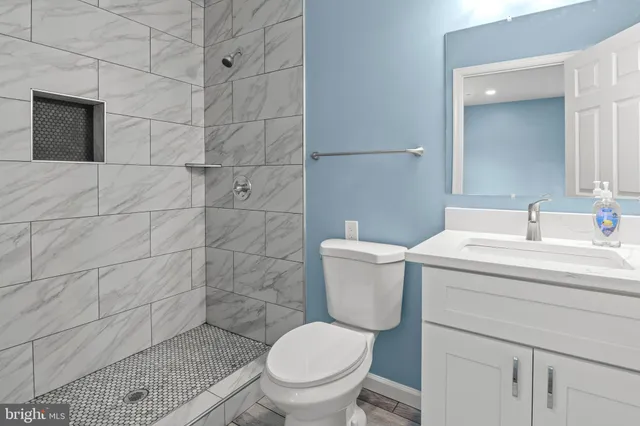 a white toilet sitting next to a bathroom sink