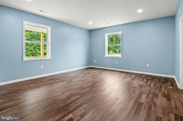 a view of room with window and wooden floor