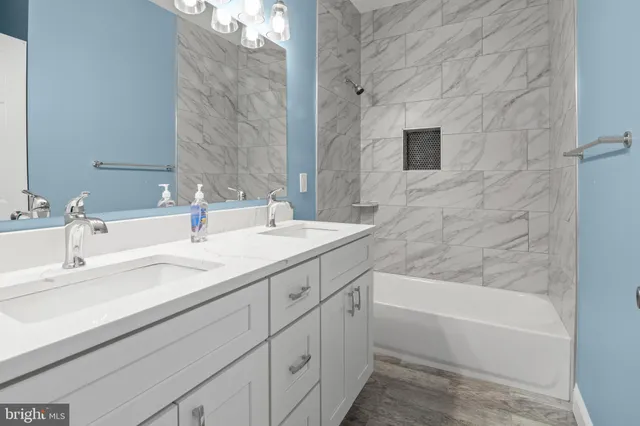 a bathroom with a bathtub and a sink