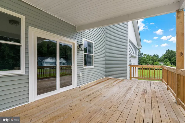 a view of backyard with a deck and wooden floor