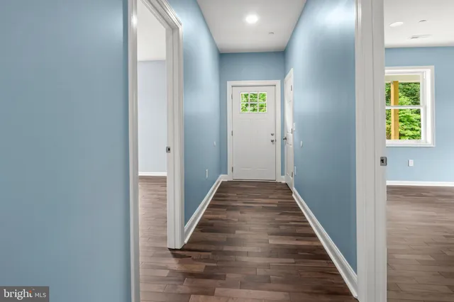 a view of hallway with wooden floor