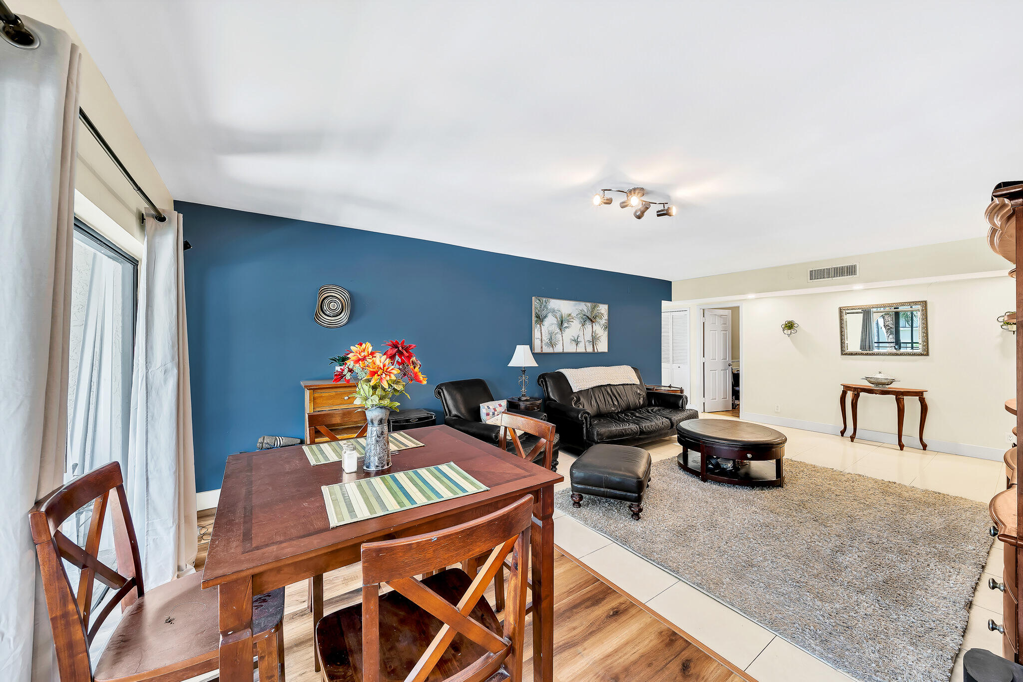 6342 Longboat Lane West, Unit 201 Boca Raton, FL 33433 - Photo 12 of 40 a living room with furniture a desk and chair with a bookshelf