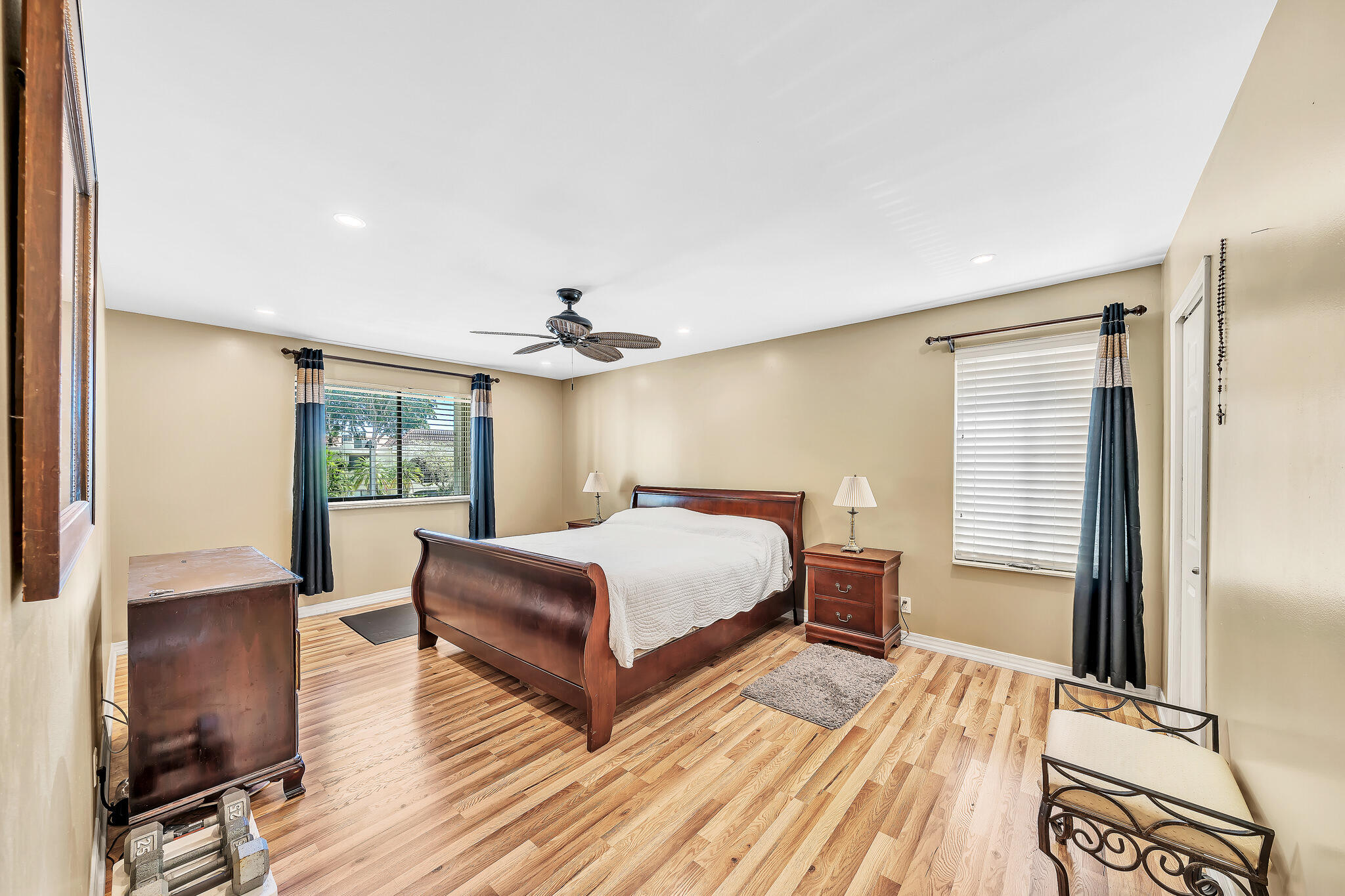 6342 Longboat Lane West, Unit 201 Boca Raton, FL 33433 - Photo 18 of 40 a bedroom with a bed and wooden floor