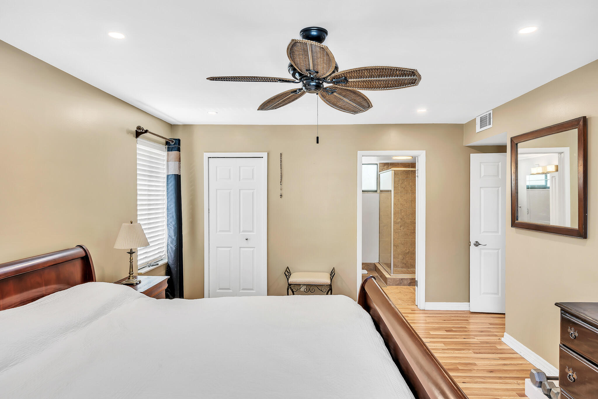 6342 Longboat Lane West, Unit 201 Boca Raton, FL 33433 - Photo 19 of 40 a bedroom with a bed and a chandelier