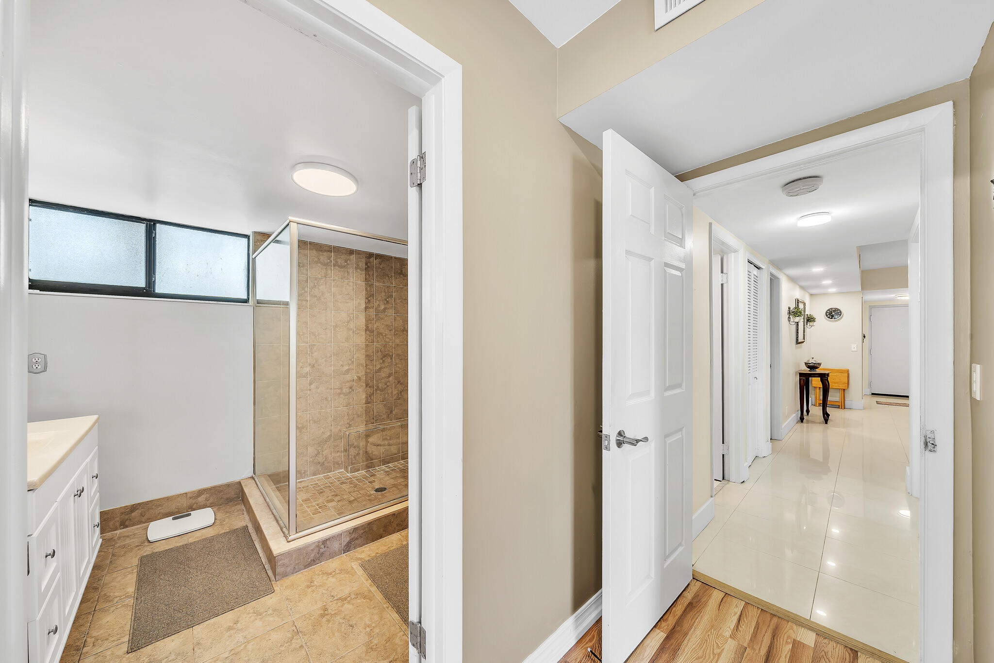 6342 Longboat Lane West, Unit 201 Boca Raton, FL 33433 - Photo 24 of 40 a view of a bathroom with a tub and shower