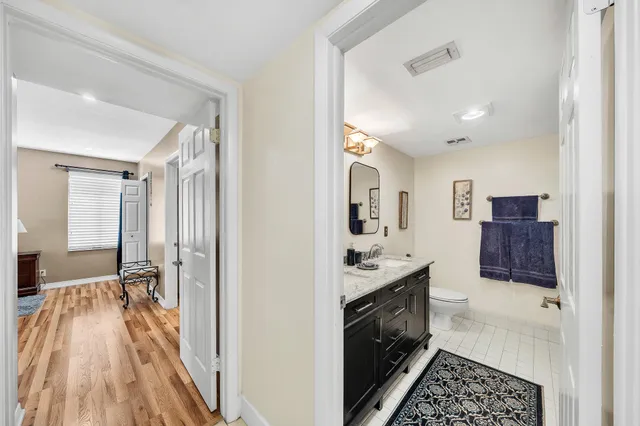 a kitchen with a sink and wooden floor