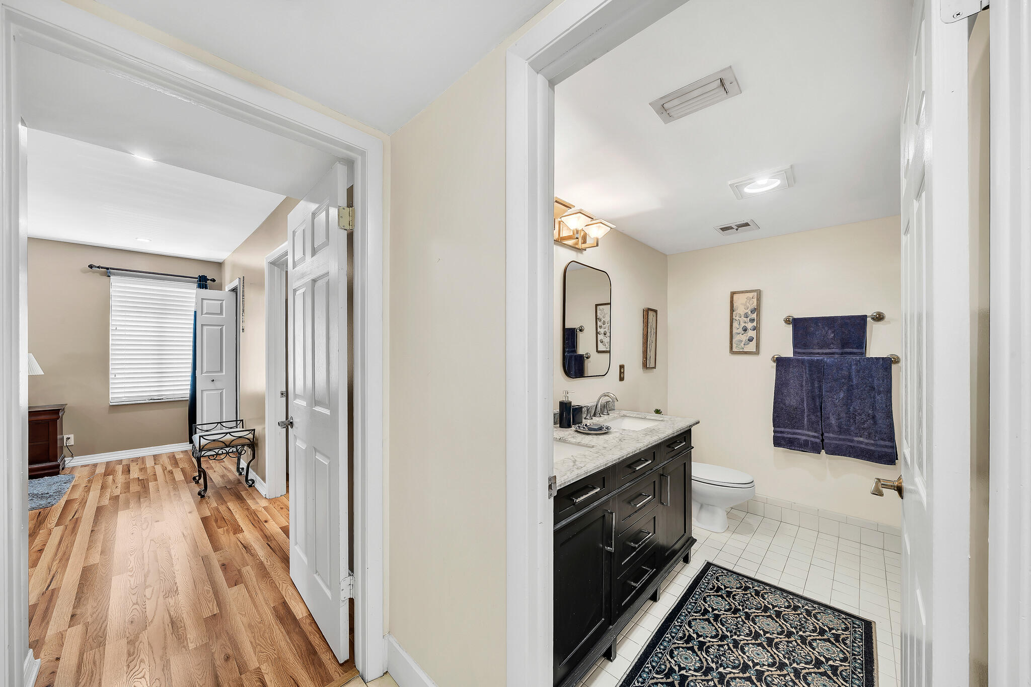 6342 Longboat Lane West, Unit 201 Boca Raton, FL 33433 - Photo 28 of 40 a kitchen with a sink and wooden floor
