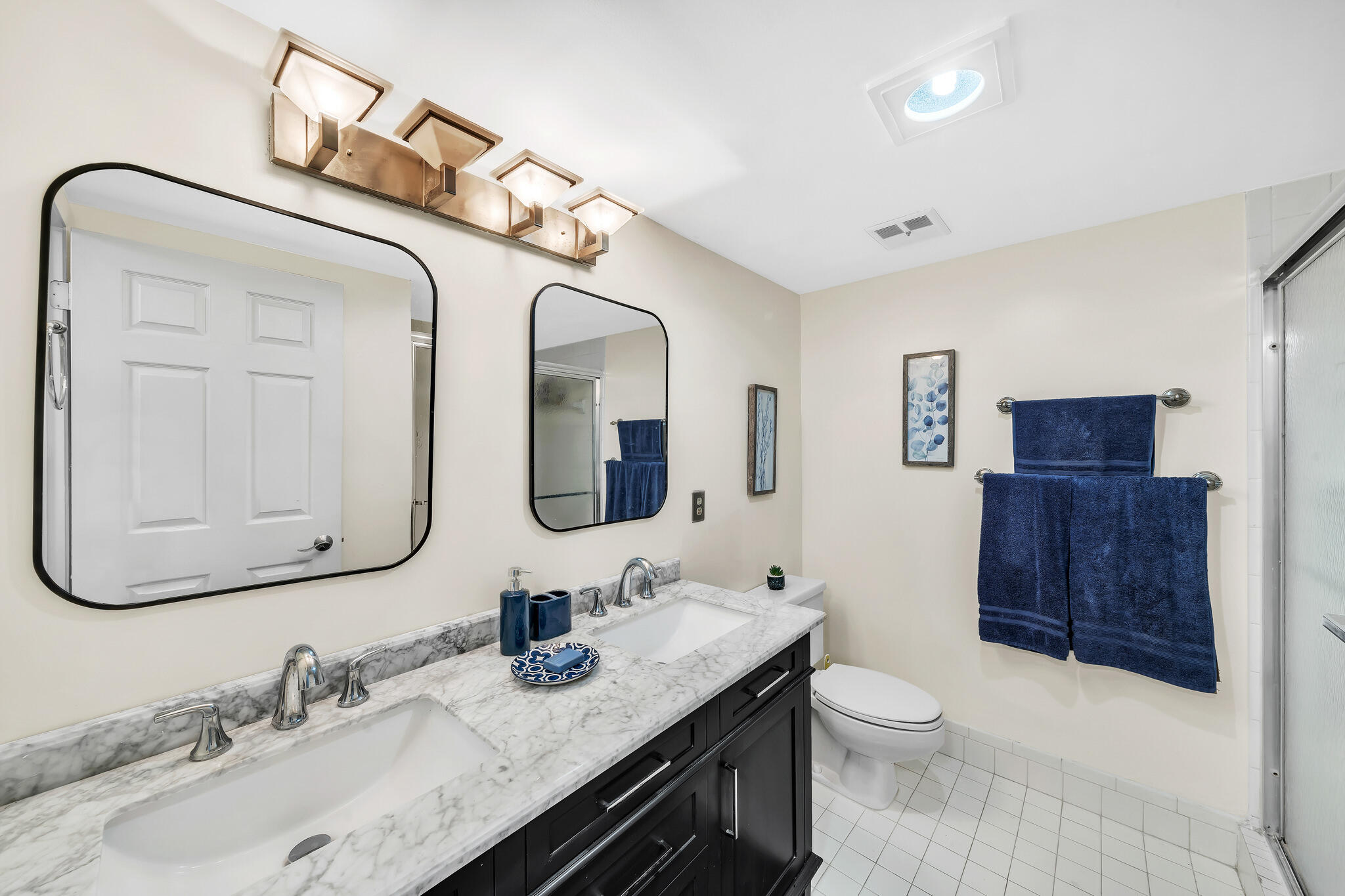 6342 Longboat Lane West, Unit 201 Boca Raton, FL 33433 - Photo 29 of 40 a bathroom with a granite countertop sink vanity mirror bathtub and toilet