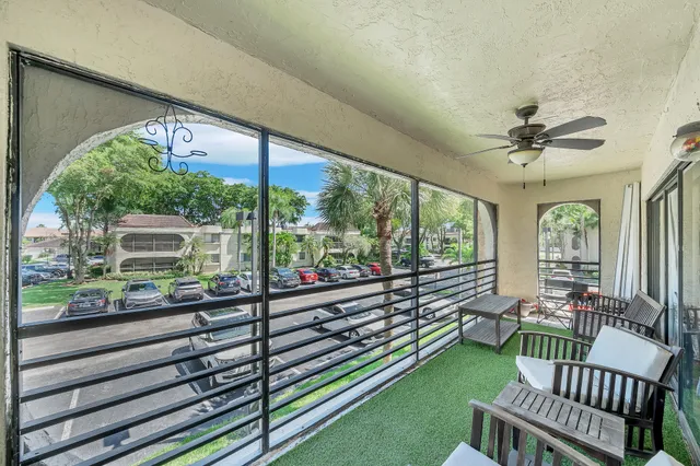 a view of a porch with furniture and a yard