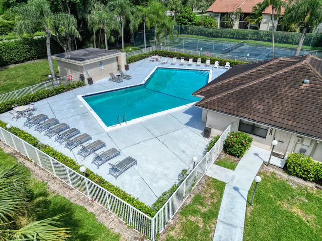 an aerial view of a house with a garden and trees