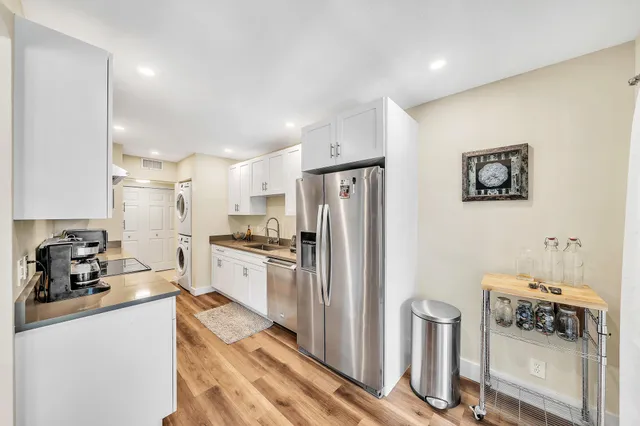 a kitchen with stainless steel appliances granite countertop a refrigerator and a stove top oven