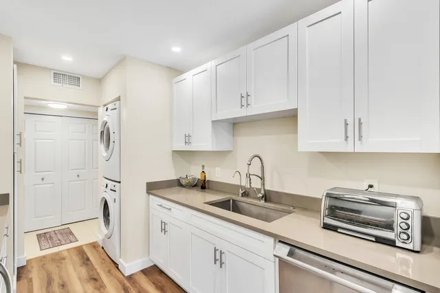 a kitchen with stainless steel appliances a refrigerator sink and cabinets