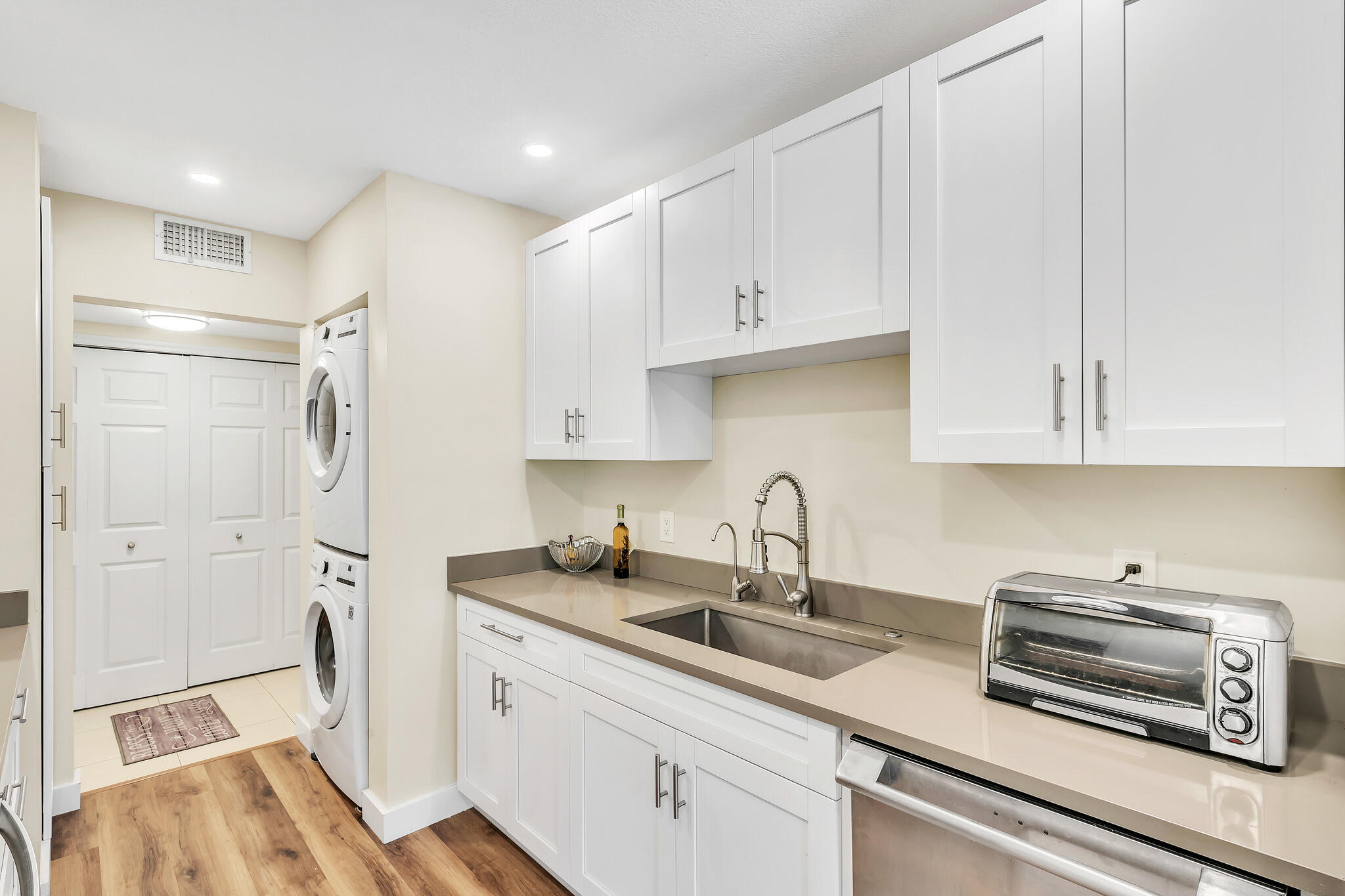 6342 Longboat Lane West, Unit 201 Boca Raton, FL 33433 - Photo 7 of 40 a kitchen with stainless steel appliances a refrigerator sink and cabinets