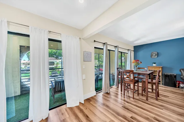 a dining room with furniture window and wooden floor