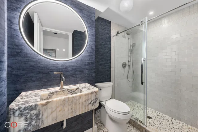 a bathroom with a sink toilet and shower