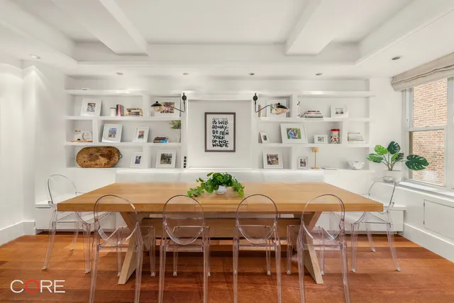 a view of a dining room with furniture and chandelier