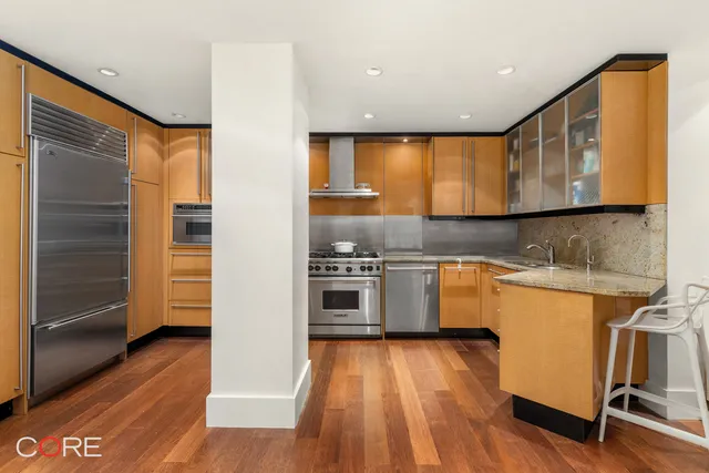 a kitchen with a wooden floor and window