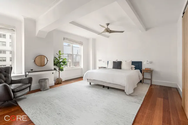 a bedroom with a bed and ceiling fan