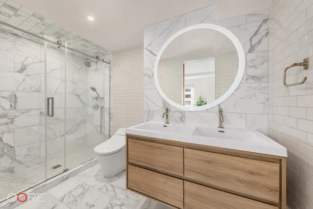 a bathroom with a sink mirror toilet and shower