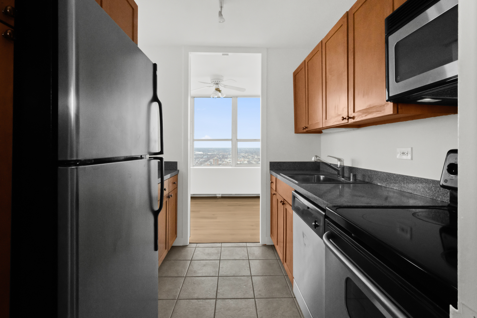 655 West Irving Park Road, Unit 4417 Chicago, IL 60613 - Photo 11 of 24 a kitchen with stainless steel appliances granite countertop a refrigerator and a stove top oven