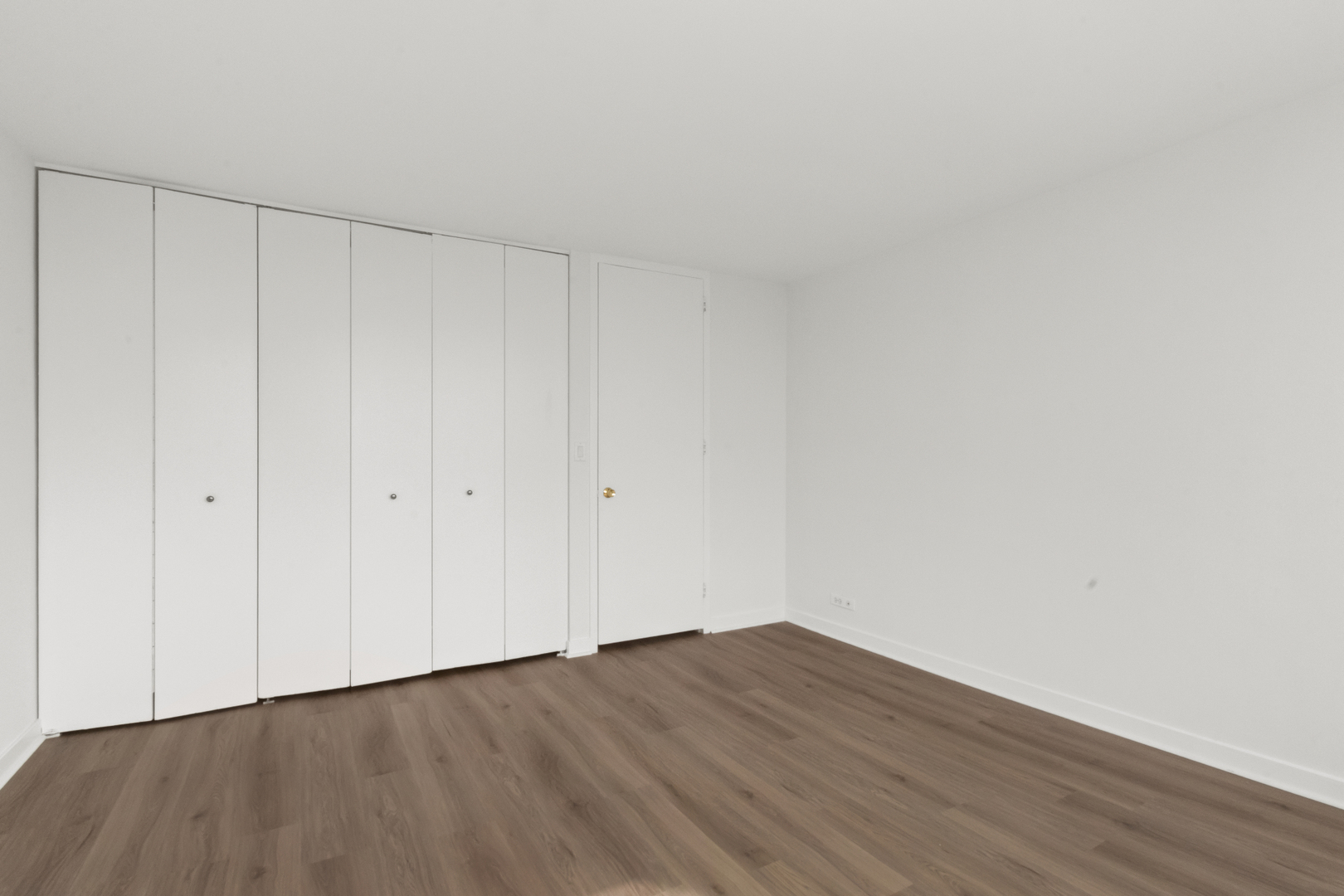 655 West Irving Park Road, Unit 4417 Chicago, IL 60613 - Photo 13 of 24 a view of an empty room with wooden floor
