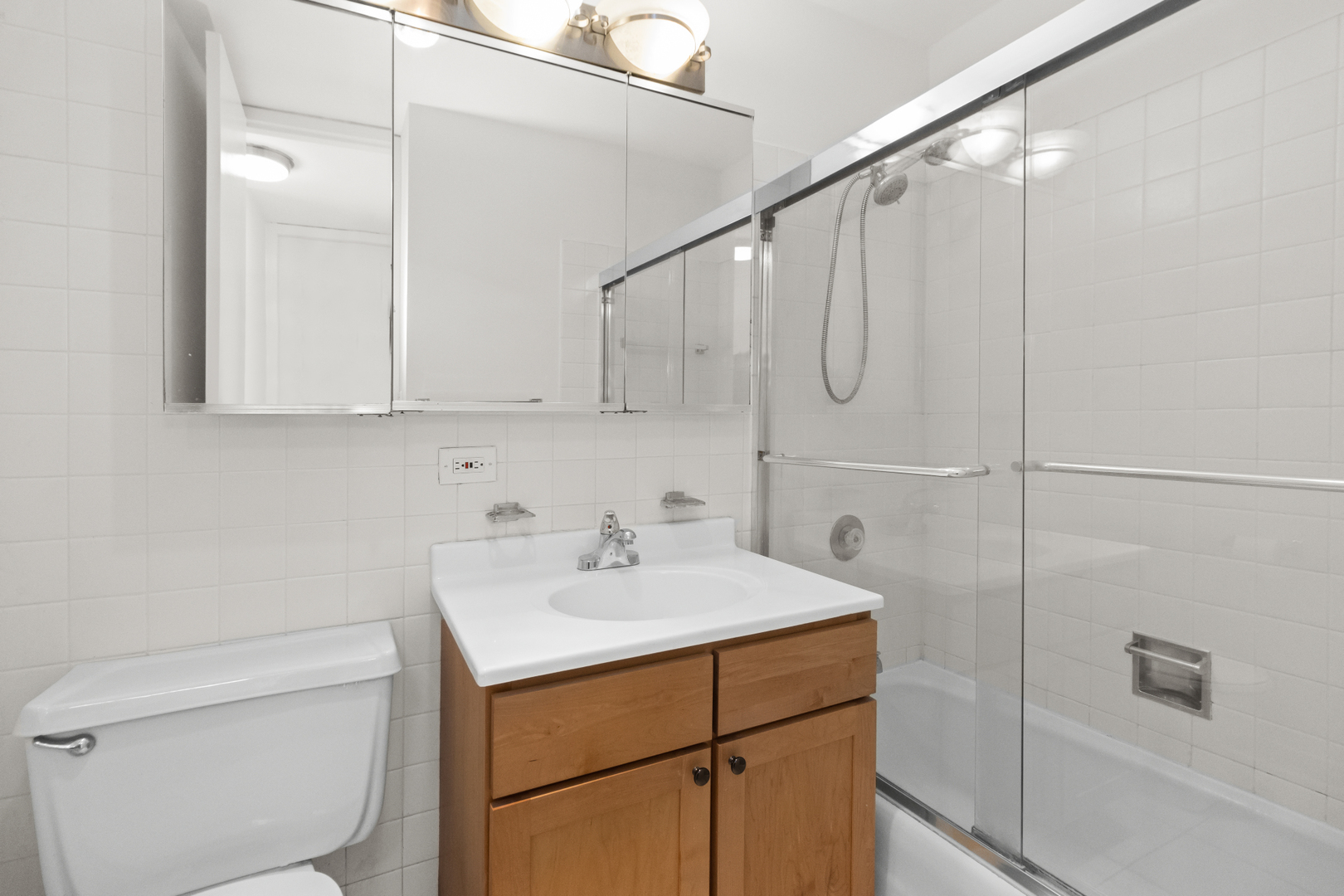 655 West Irving Park Road, Unit 4417 Chicago, IL 60613 - Photo 14 of 24 a bathroom with a sink toilet vanity and tub