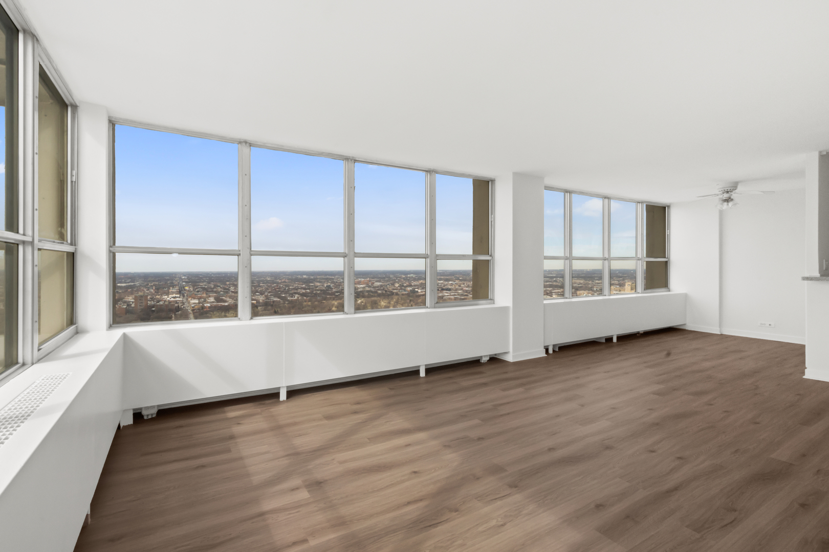 655 West Irving Park Road, Unit 4417 Chicago, IL 60613 - Photo 8 of 24 a view of an empty room with a window and wooden floor