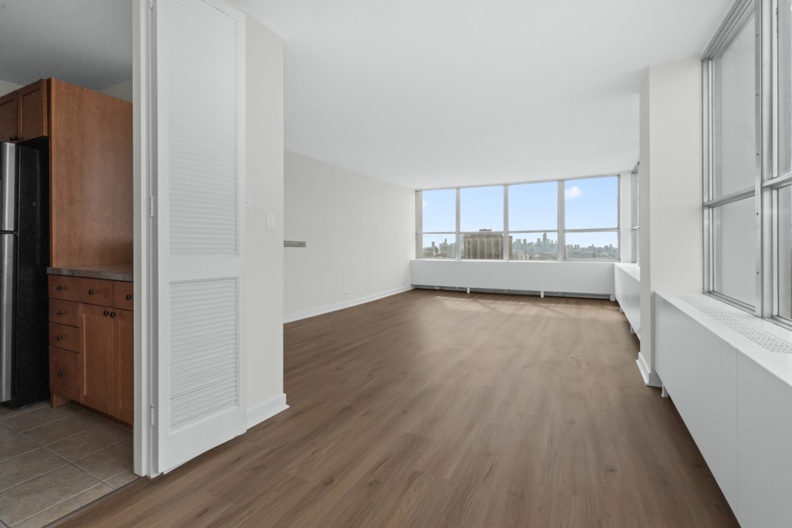 655 West Irving Park Road, Unit 4417 Chicago, IL 60613 - Photo 9 of 24 a view of a kitchen with wooden floor and electronic appliances