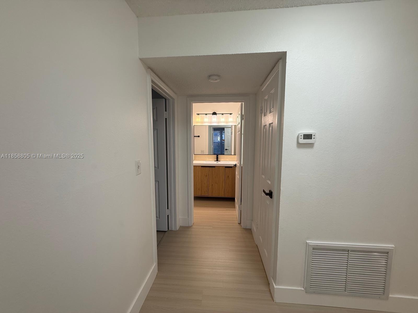 2319 North Congress Avenue, Unit 15 Boynton Beach, FL 33426 - Photo 12 of 20 a view of a hallway with a livingroom and a bathroom